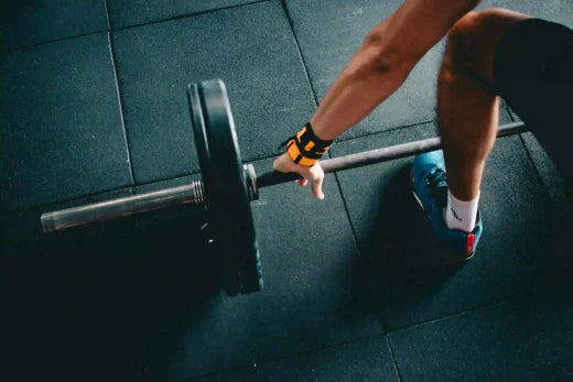 man lifting a bar with weighs in the gym