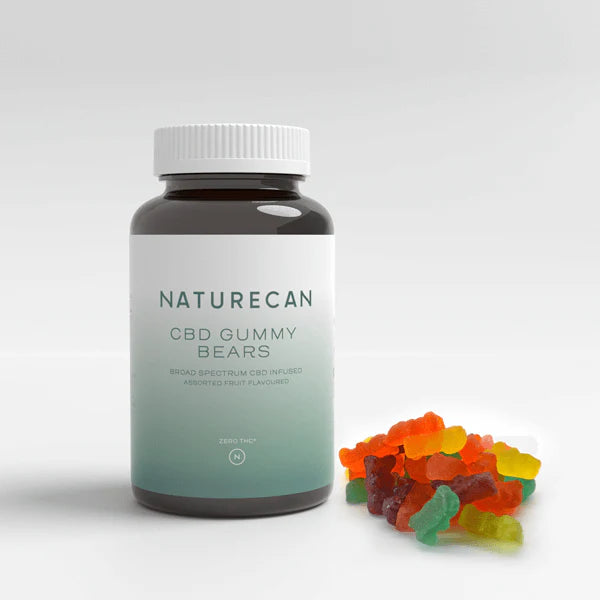 Naturecan CBD Gummy Bears bottle with assorted colorful gummies beside it.