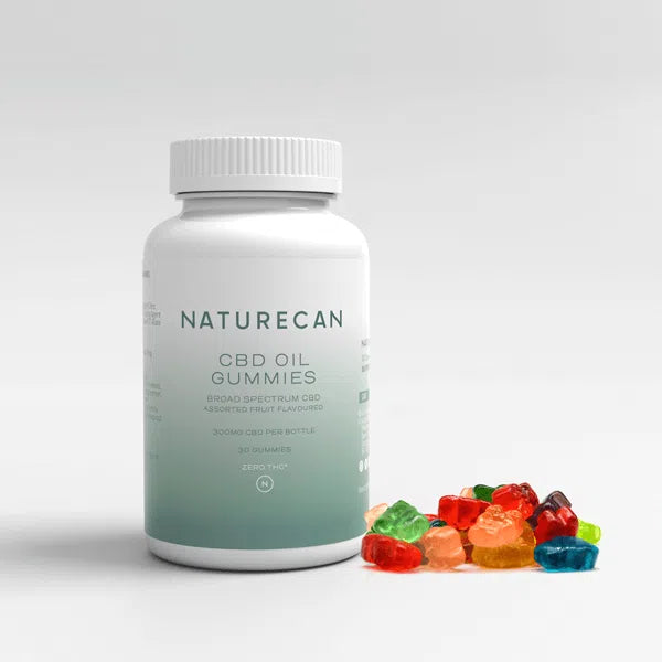 Naturecan CBD oil gummies bottle with assorted colorful gummies beside it.