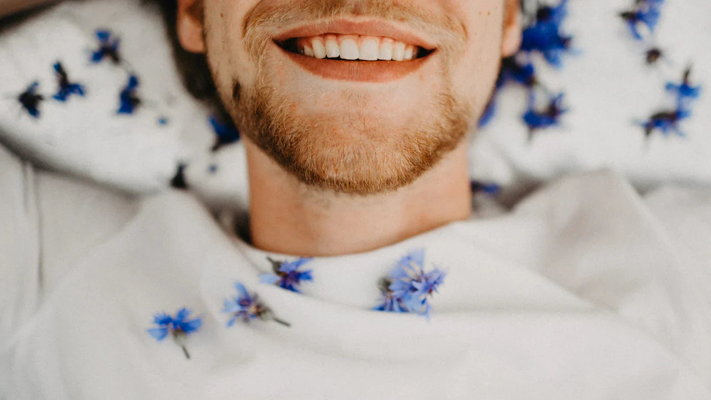 man smiling covered with flowers