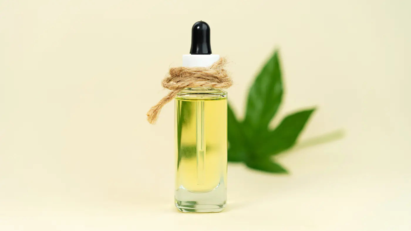 THC oil flask over yellow background
