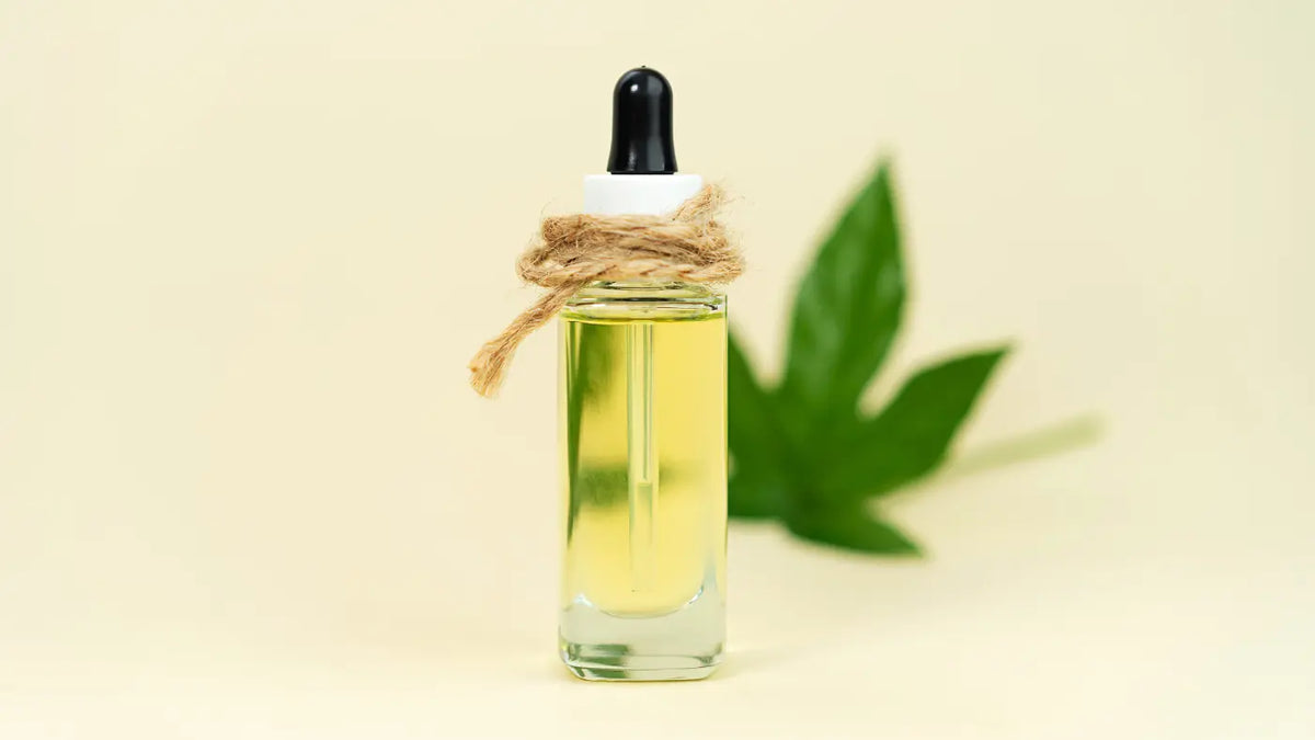 THC oil flask over yellow background