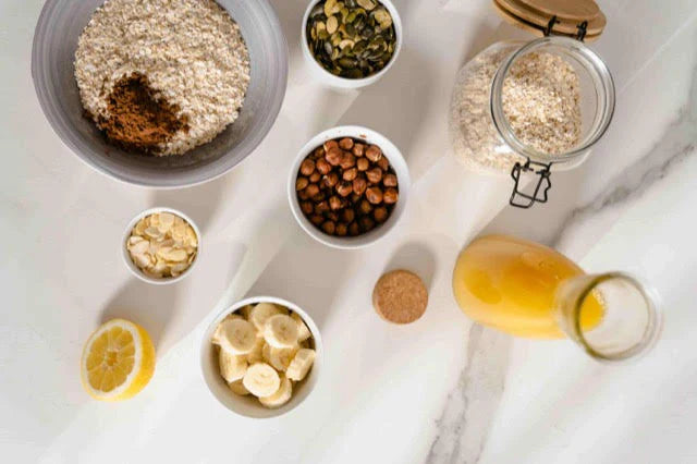 table with oats, hazelnuts, lemon, banana, orange juice, etc.