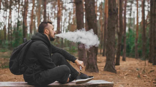 Man sitting and vaping 