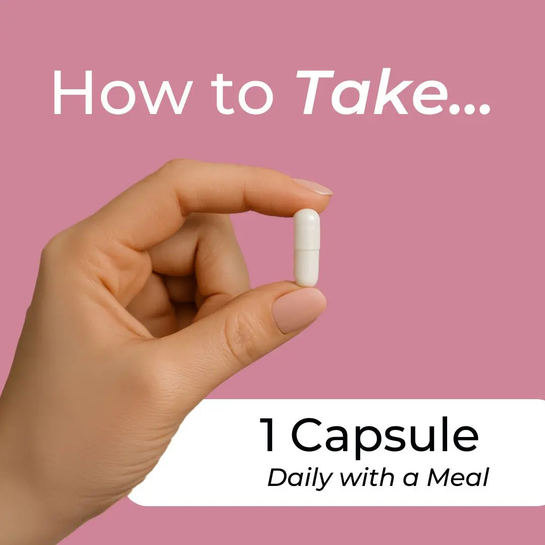 Hand holding a white capsule with text on a pink background