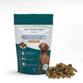 Naturecan Pets CBD calming dog chews packaging with chicken liver flavor and a pile of chews beside it.