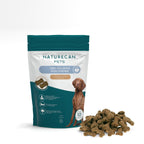 Naturecan Pets CBD calming dog chews in chicken liver flavor packaging with a pile of chews beside it.