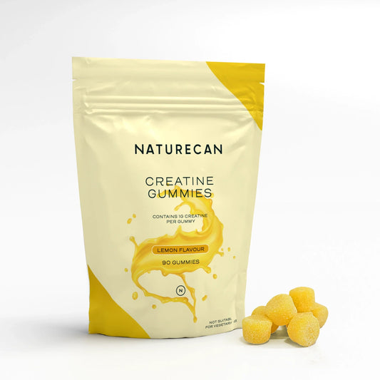 Naturecan Creatine Gummies packaging with lemon flavor, 90 gummies, next to a small pile of yellow gummies.
