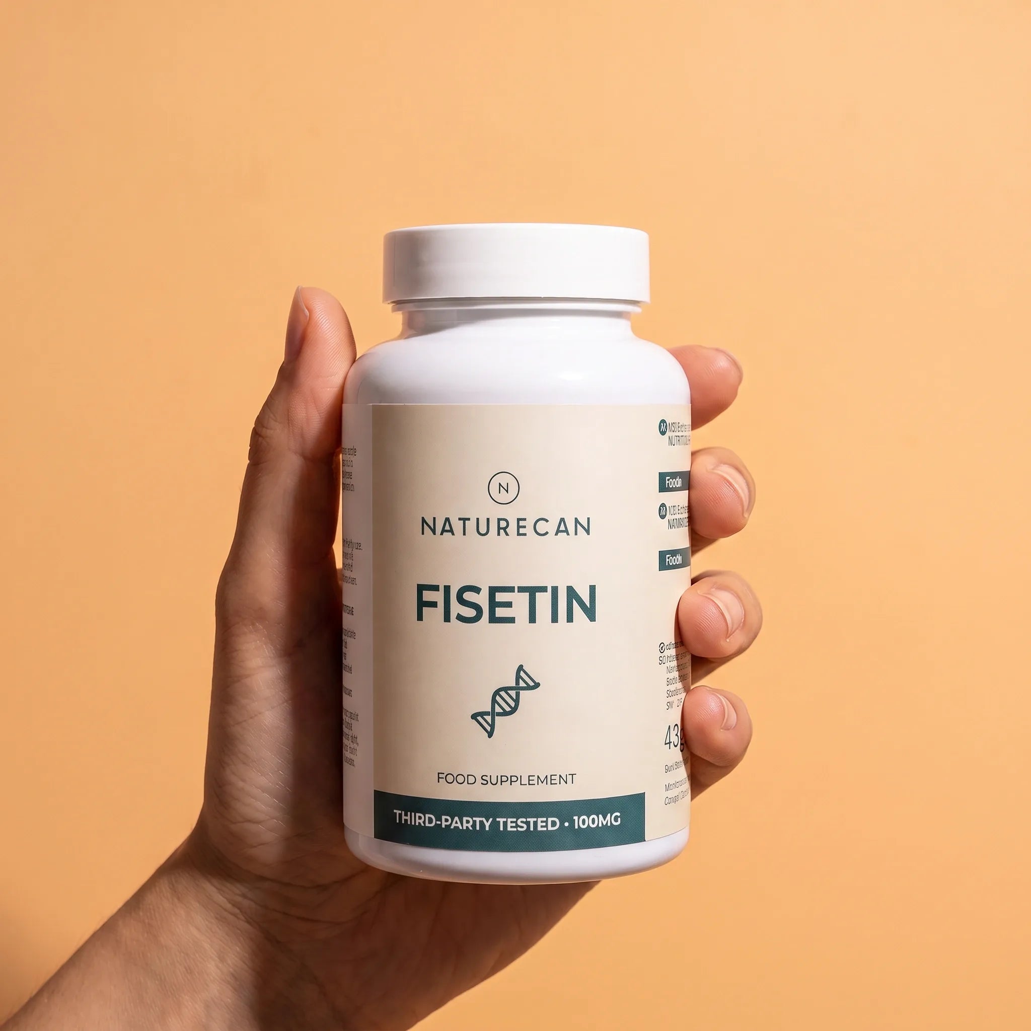 A hand holding a white bottle of Naturecan Fisetin food supplement against a solid peach-colored background.