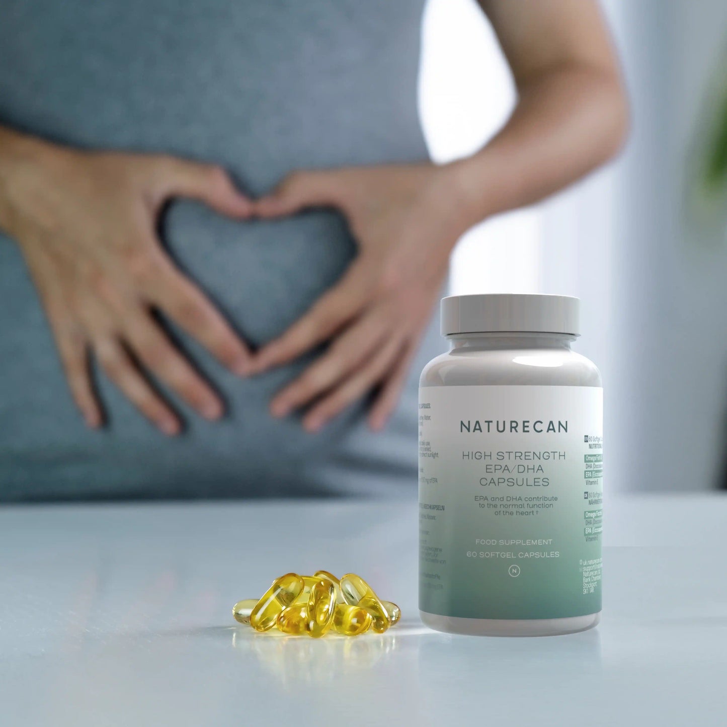 Naturecan High Strength EPA capsules with a person making a heart shape on their stomach.