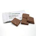 CBD-infused milk chocolate squares with Naturecan packaging in the background.
