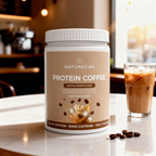 Naturecan Protein Coffee container on a table with a glass of iced coffee in the background.