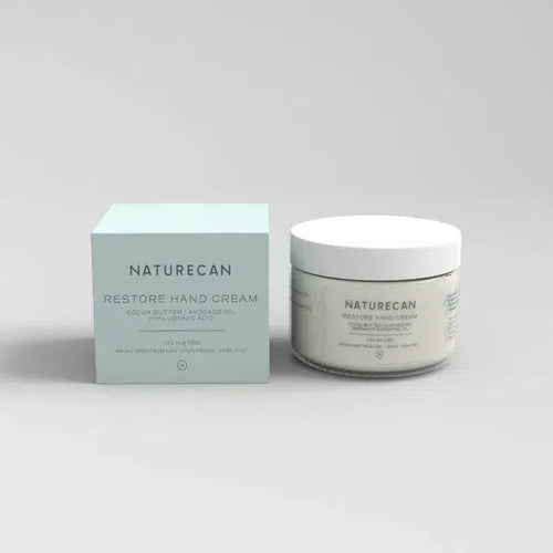 Naturecan Restore Hand Cream packaging and jar with cocoa butter and avocado oil.