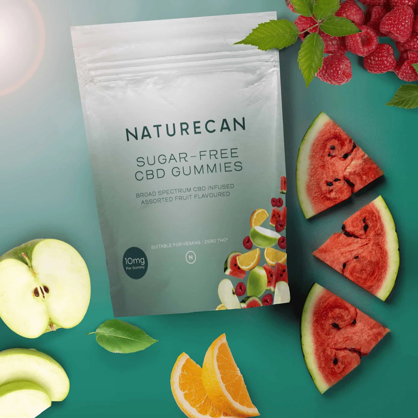 Naturecan sugar-free CBD gummies package with fruit slices and leaves on a green background.