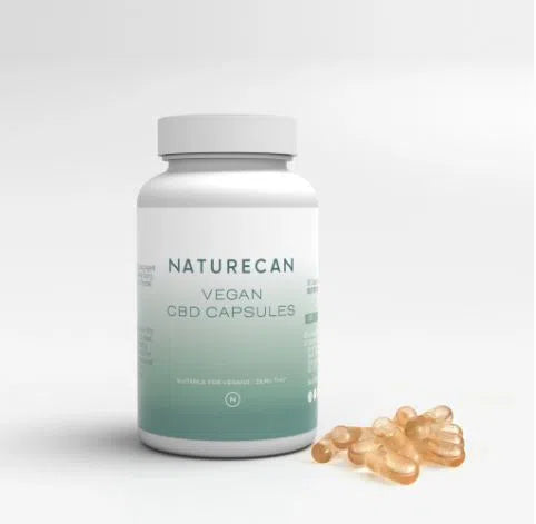 Naturecan Vegan CBD capsules bottle with scattered softgel capsules beside it.